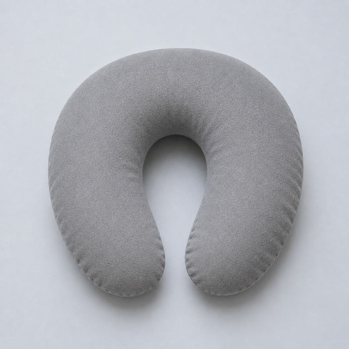 A standard U-shaped travel pillow from above, open at the front