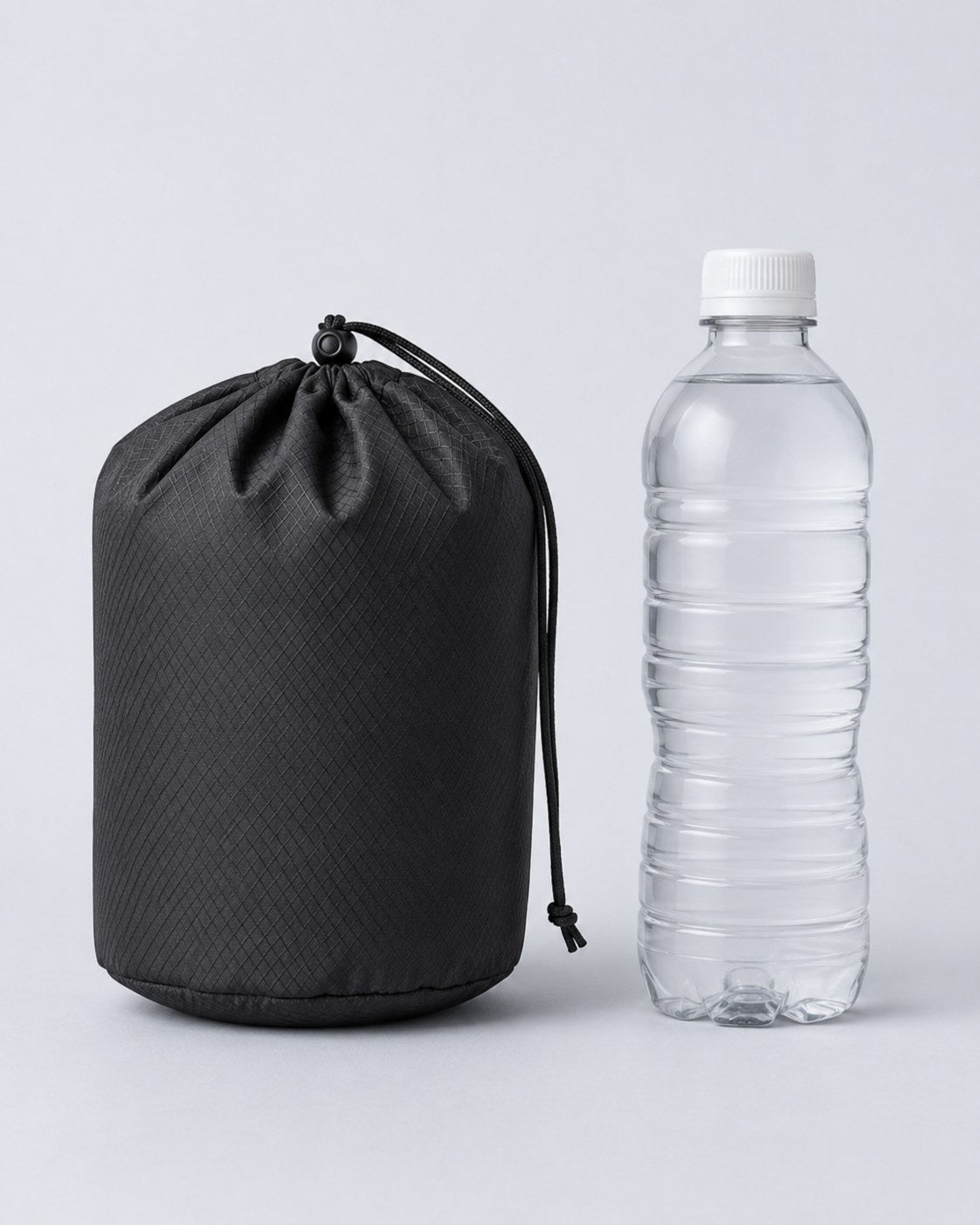 The carry case packed down beside a water bottle for scale